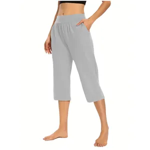 Detail view of women's grey loose cropped pants with pockets and elastic waist