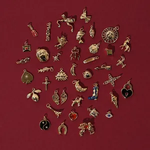 Close-up detail of assorted 18k gold-plated stainless steel charms for DIY jewelry making
