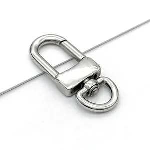 Close-up macro view of a polished stainless steel swivel lobster clasp for keychains.