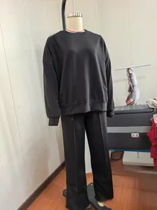 Full view of black knit leisure set with sweatshirt and wide-leg pants on mannequin