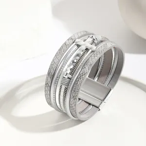 Detailed view of silver multi-layer leather cross bracelet with magnetic clasp