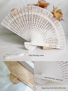 Detail of white laser-cut wooden folding fan showing custom engraving and tassel options.