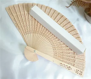Elegant hollowed-out wooden folding fan with a minimalist white gift packaging box