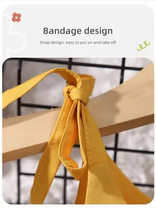 Close-up of yellow cotton girl's dress with adjustable bandage strap design