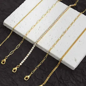 Detailed close-up showing five distinct gold-finish anklet chain styles on a white stone block.