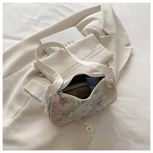 Chic gradient star denim shoulder bag with frayed edges and cream leather strap.