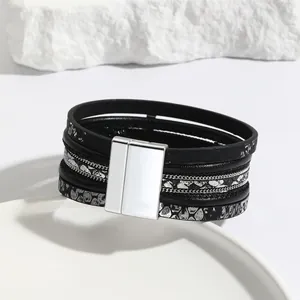 Macro view of multilayer leather bracelet with silver magnetic clasp and chain details