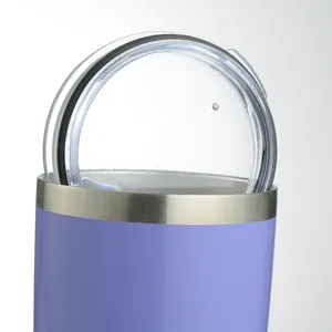 Macro detail view showing the clear plastic lid and metallic rim of a purple travel tumbler