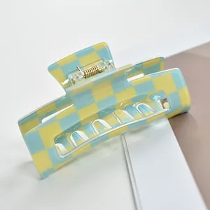 Large blue and yellow checkered hair claw clip featuring a rectangular hollow-out design