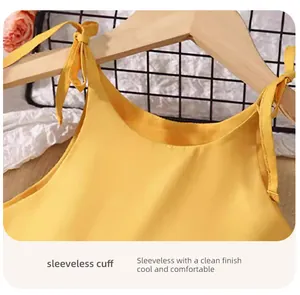 Close-up detail of yellow girls' sleeveless strap dress with clean finish neck design