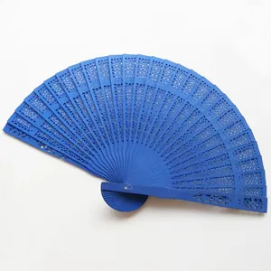 Detailed view of a vibrant blue hollow-carved wooden folding fan for wedding events