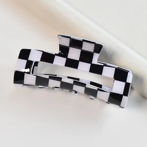 Modern black and white checkered pattern hair claw clip with square geometric design for women