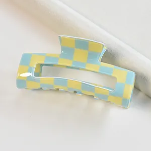 Square hair claw clip with blue and yellow checkerboard pattern for styling hair