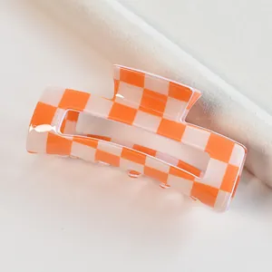 Orange and cream checkered pattern square hair claw clip variant for stylish hairstyling