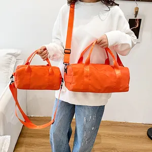 Bright orange nylon cylindrical duffel bags in two sizes for fitness and travel