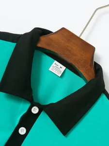 Close-up detail of a teal men's polo shirt featuring black collar and size M fabric tag