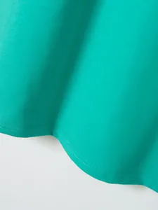 Close-up detail of teal cotton twill fabric hem with neat double stitching.