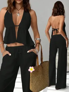 Professional detail view of black halter backless top and wide-leg trousers set