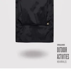 Close-up view of a black outdoor workwear vest featuring a functional zipper pocket detail.