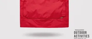 Detailed close-up of a red outdoor vest with zippered pockets and durable fabric