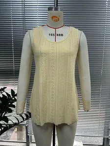 Close-up detail of a yellow sleeveless knit top featuring an intricate eyelet pattern