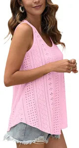 Detail view of a pink sleeveless tank top with hollow-out eyelet floral pattern.