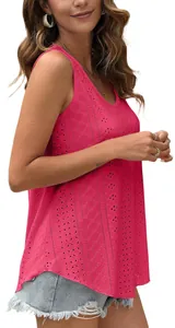 Detail of rose pink sleeveless top featuring intricate geometric eyelet embroidery.