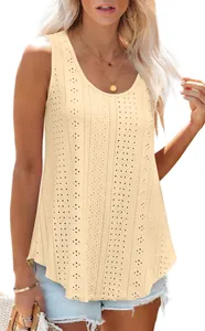 Detailed shot of beige sleeveless tank top with delicate eyelet embroidery and loose fit.