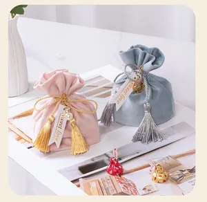 Close-up of elegant velvet gift bags with gold tassels and Sweet Love tags