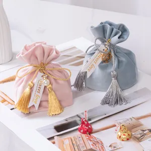 Elegant velvet wedding candy bags with decorative tassels and Sweet Love tags for gift favors