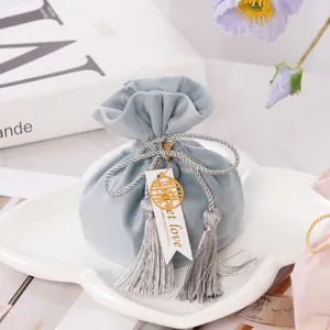 Elegant blue velvet wedding favor bag with silver tassels and golden double happiness charm