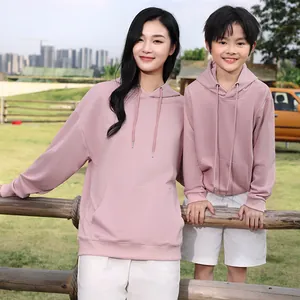 Oversized pink hooded sweatshirt for adults and children in an outdoor scene