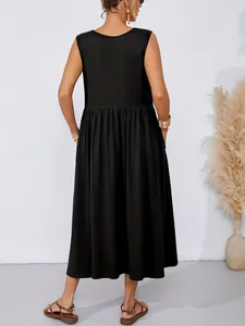 Back view of a minimalist black sleeveless loose midi dress with functional side pockets