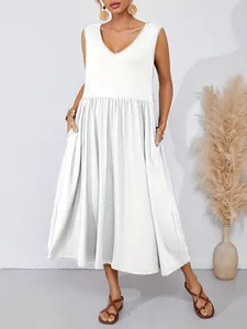 Sleeveless white V-neck midi dress with pockets shown in a minimalist studio setting