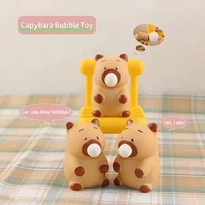 Three capybara squeeze toys showing bubble blowing feature on plaid background