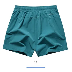 Back view of men's quick-dry teal sports shorts showing elastic waist and fabric detail