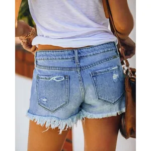 Detailed back view of women's blue distressed denim shorts with stylish frayed fringe hem