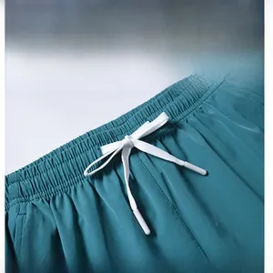 Close-up of elastic waistband with white drawstring on teal quick-dry shorts