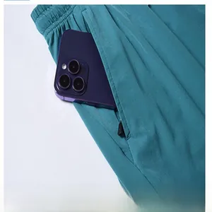Close-up of men's teal quick-dry shorts featuring a secure zipper pocket design.