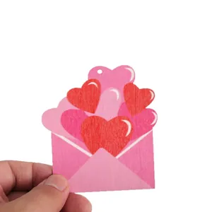 Valentine's Day wooden hanging ornament shaped like a pink envelope with red hearts