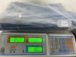 Detail view of a pair of blue denim jeans on a digital scale weighing 0.595 kilograms