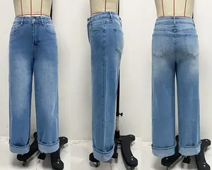 Detail view of women's high-waisted straight leg denim jeans with stylish rolled cuffs