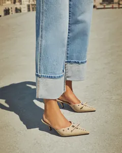 Detail of light blue high waist straight jeans with wide cuffed hems and retro style