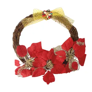 Close-up of a Christmas rattan wreath with red poinsettias, a golden mesh bow, and bells.