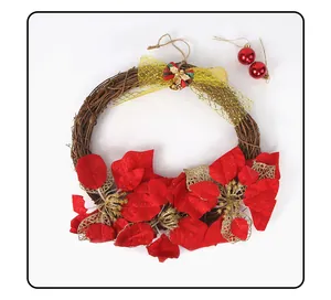 Macro detail of a rustic Christmas vine wreath decorated with red poinsettia and gold bow