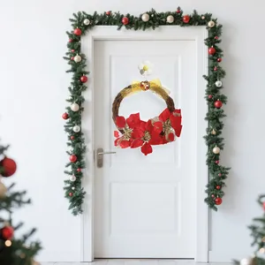 Christmas rattan wreath with red flowers and gold bow for festive door decoration