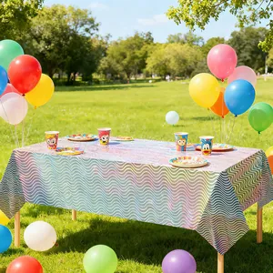 Detailansicht der irisierenden Laser-Wellen-Partytischdecke auf dem Außentisch mit Luftballons