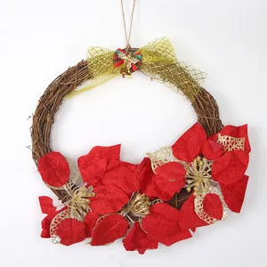 Christmas vine wreath with red poinsettia flowers and gold bow for door decoration