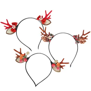 Set of three Christmas reindeer antler headbands with forest style berries and bows decor.