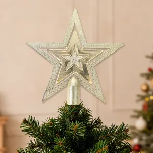 Detail view of a gold electroplated star tree topper on a Christmas tree